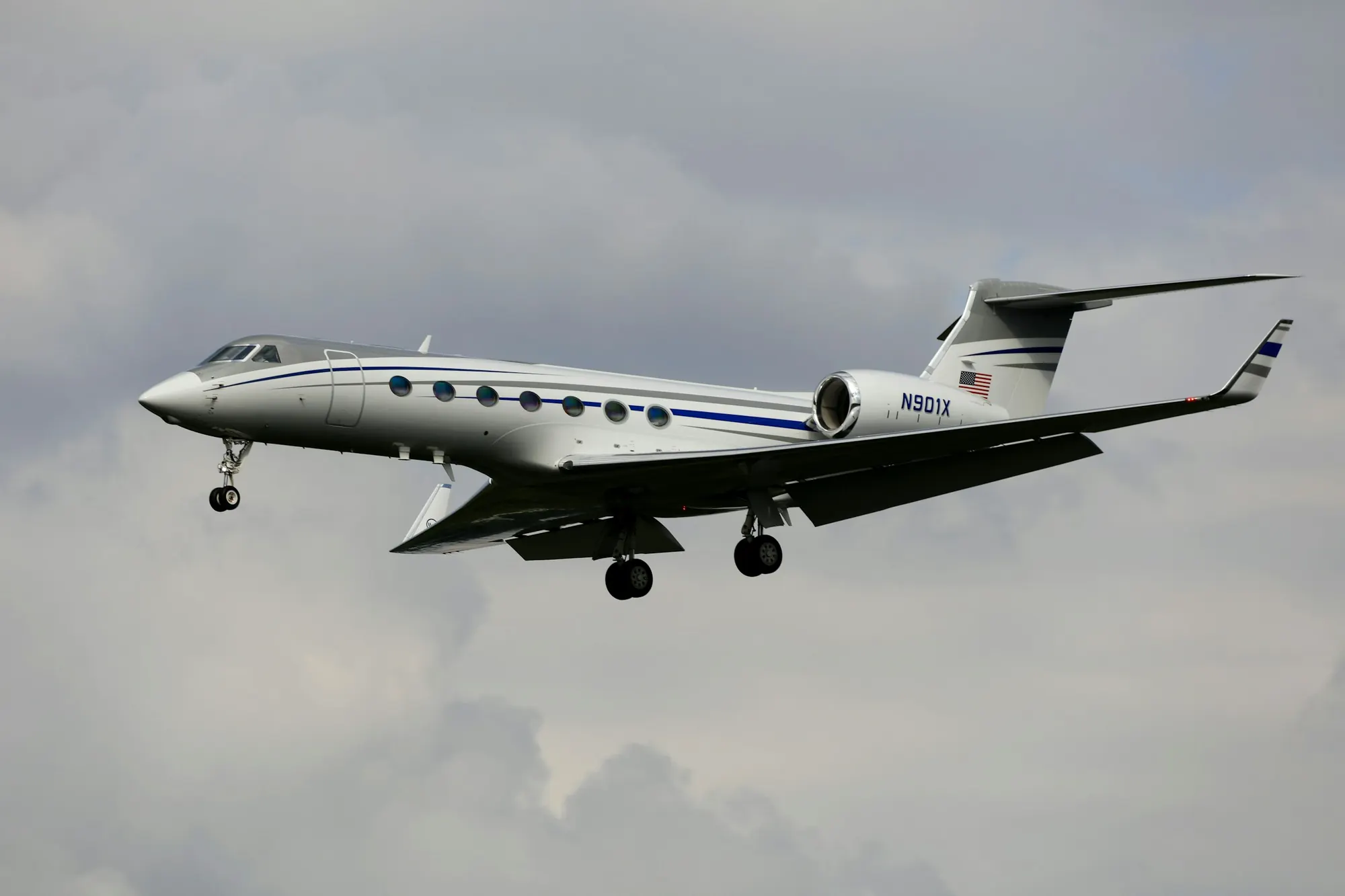 Large-cabin jet in flight against a cloudy sky