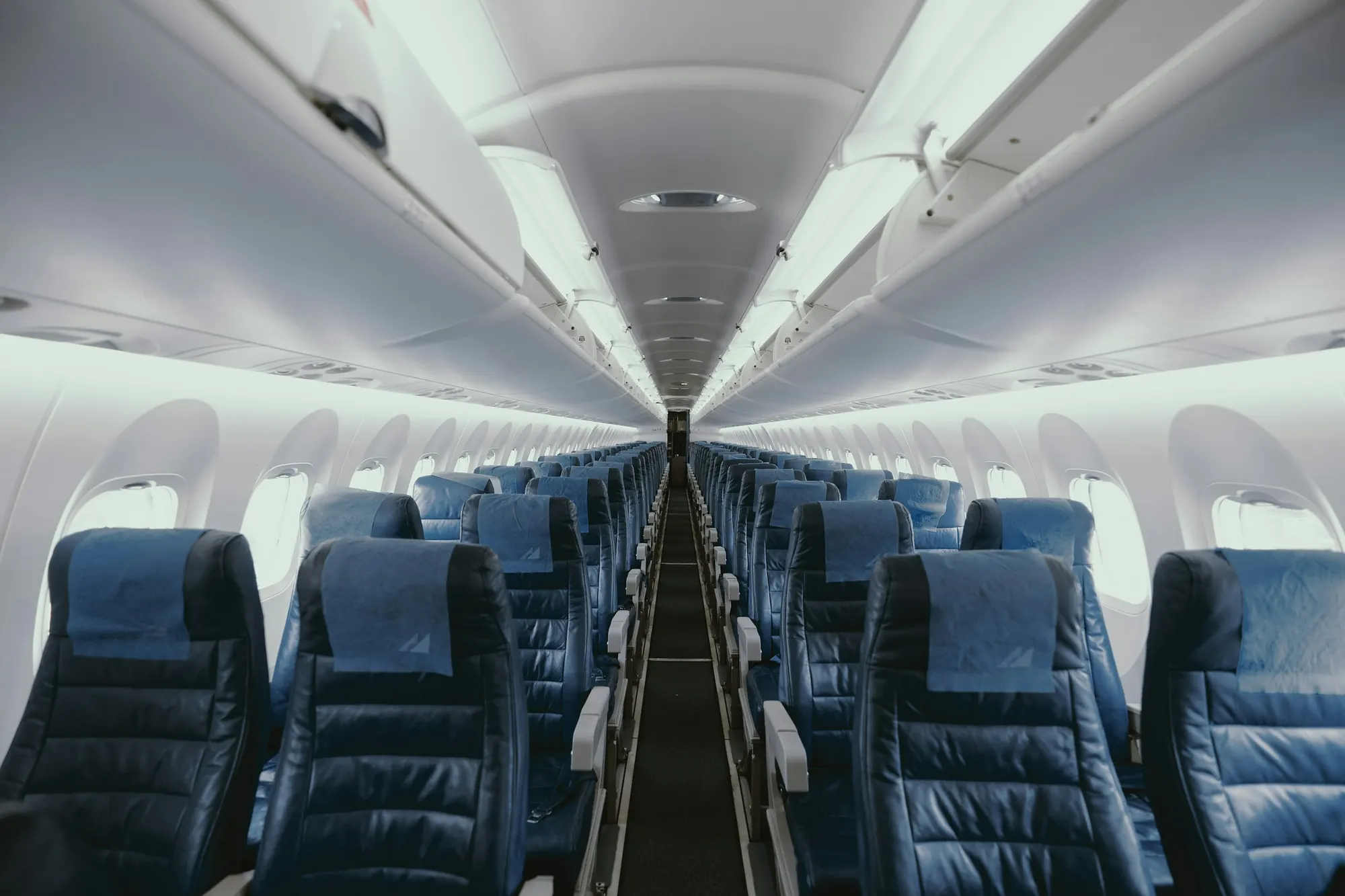 Rows of seats in a long airline cabin